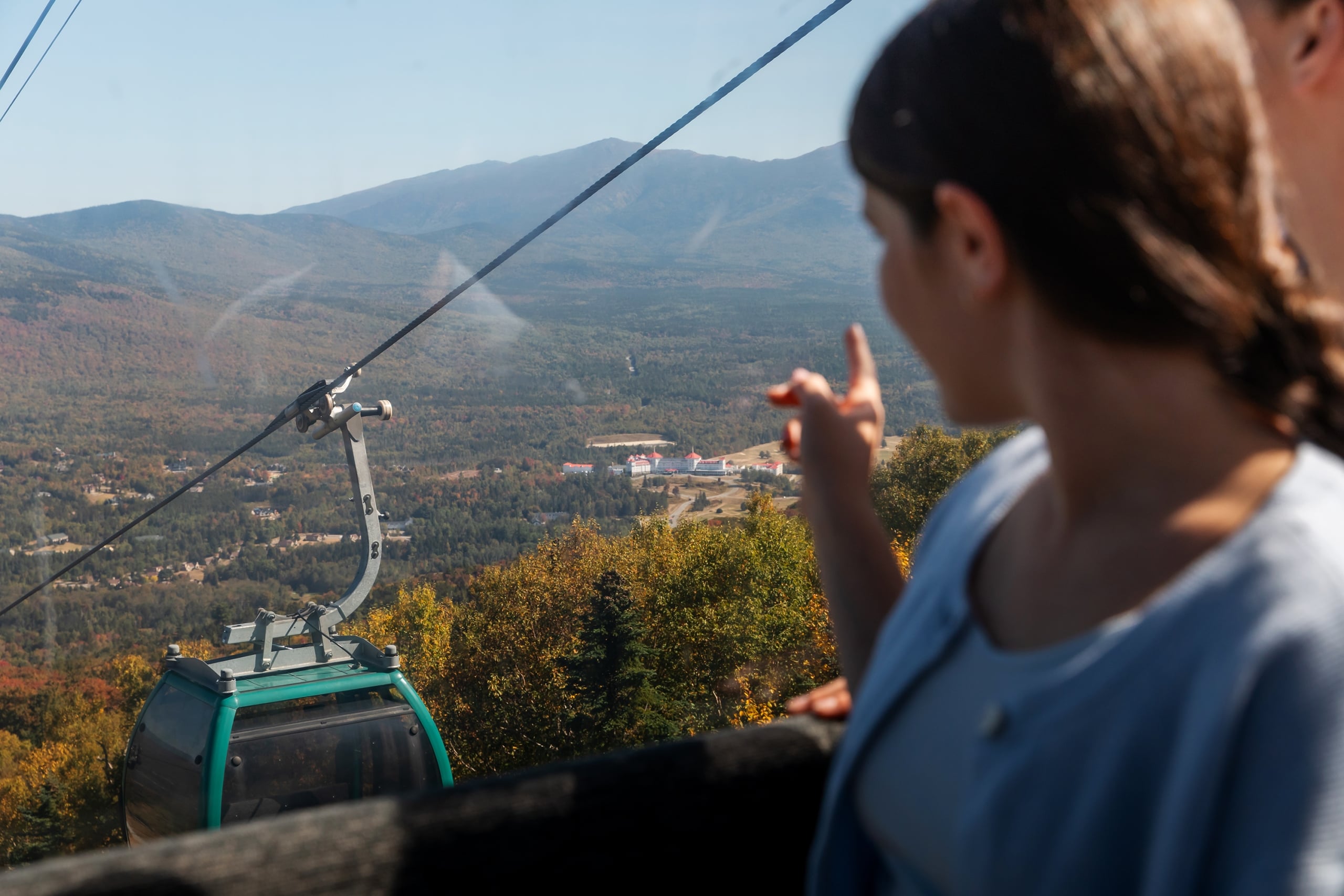 Guest looking at the view of the Omni Mount Washington Hotel and Mount Washington from the Bretton Woods Scenic Skyway Gondola