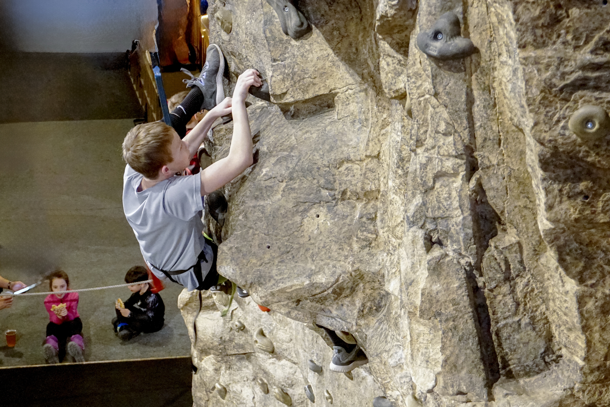 A child climbs a rock wall at Mount Washington Resort and Spa.
