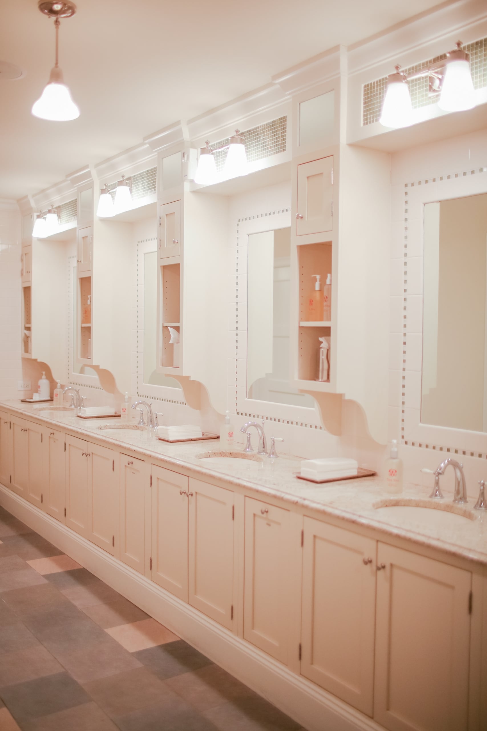 Bright, elegant spa restroom with multiple sinks, mirrors, and soft ambient lighting at Mount Washington Resort and Spa.