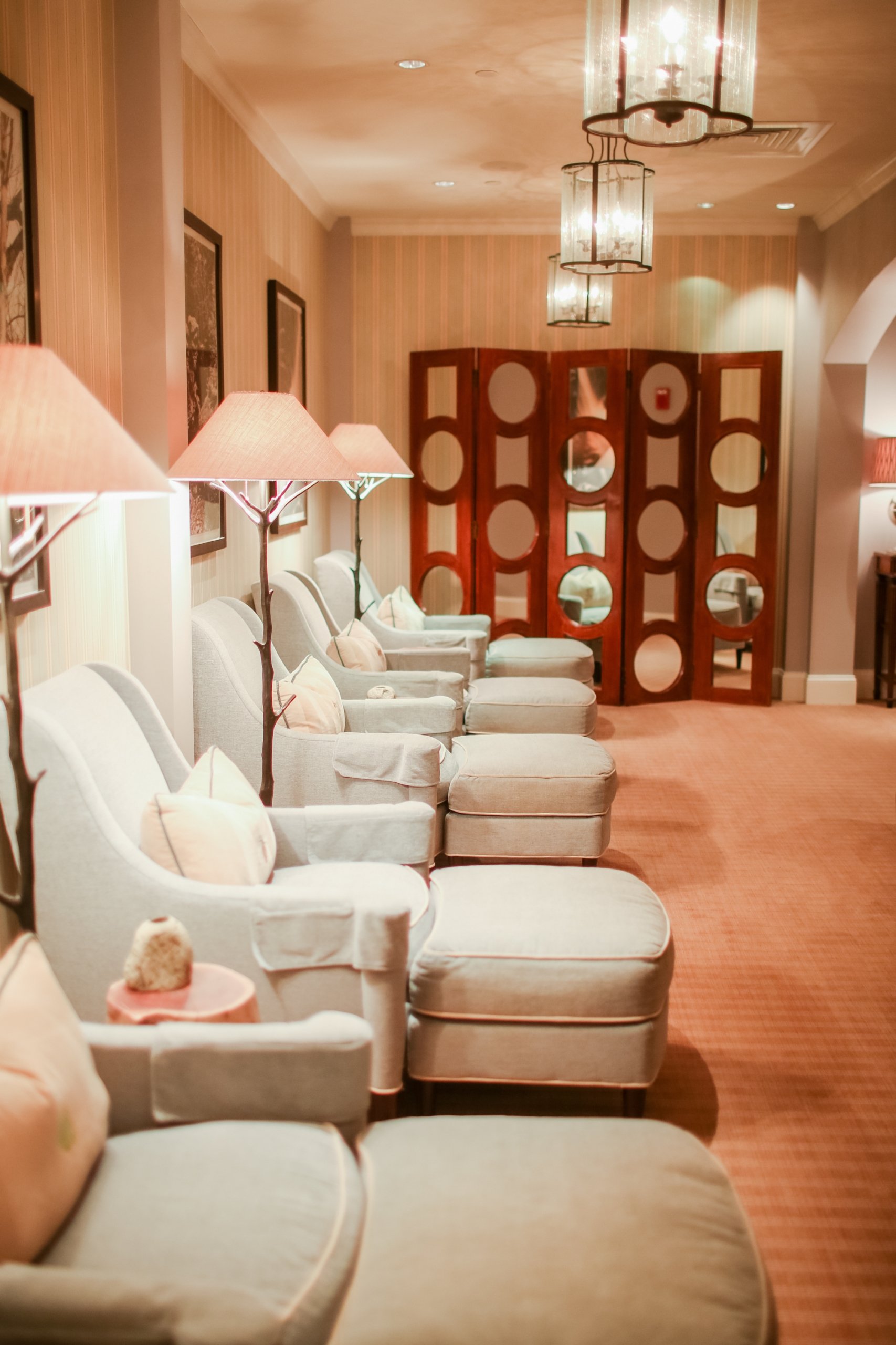 Cozy spa lounge with plush armchairs, soft lighting, and warm décor at Mount Washington Resort and Spa.