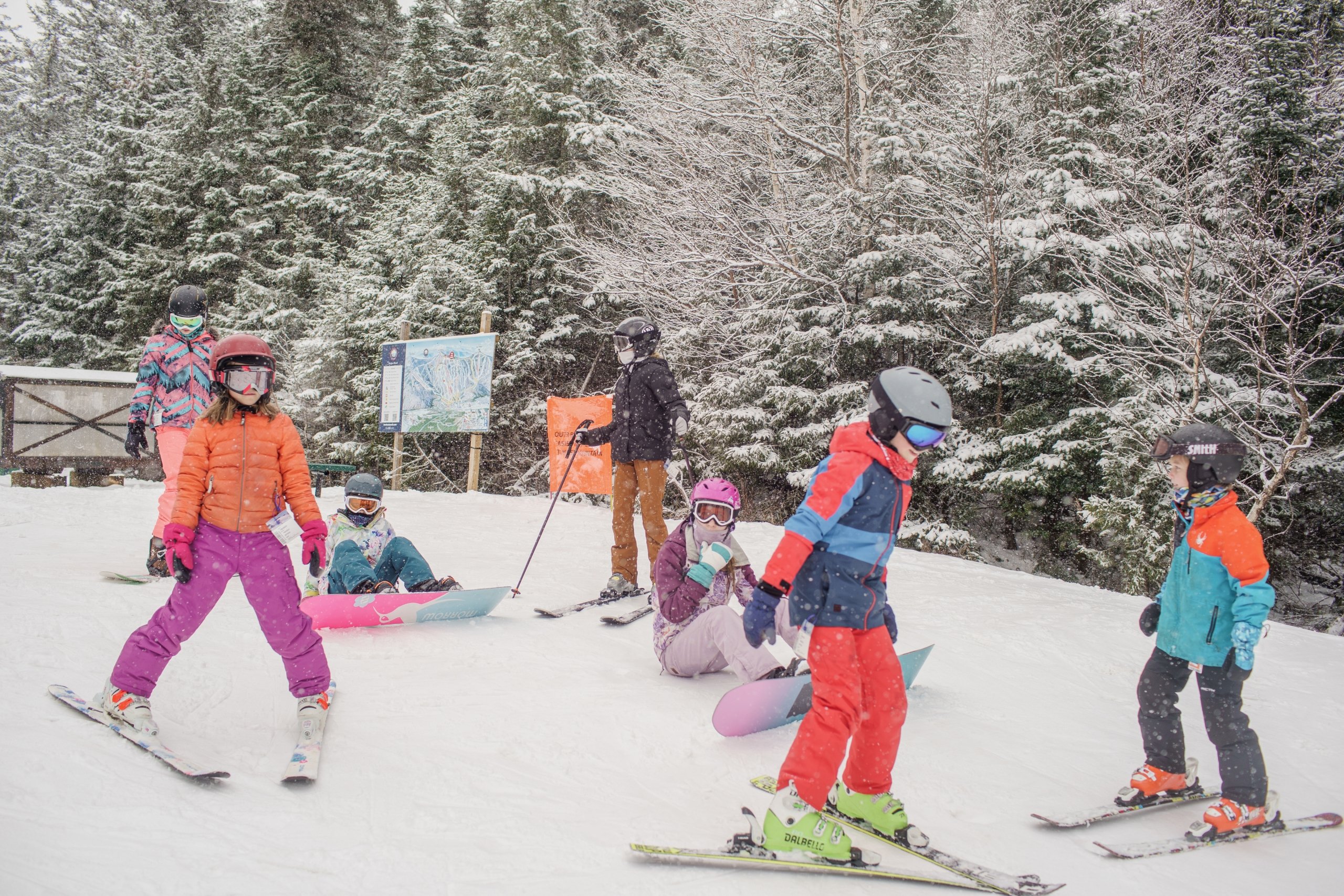 A group of kids ski down the hill together on a snowy day at Bretton Woods.