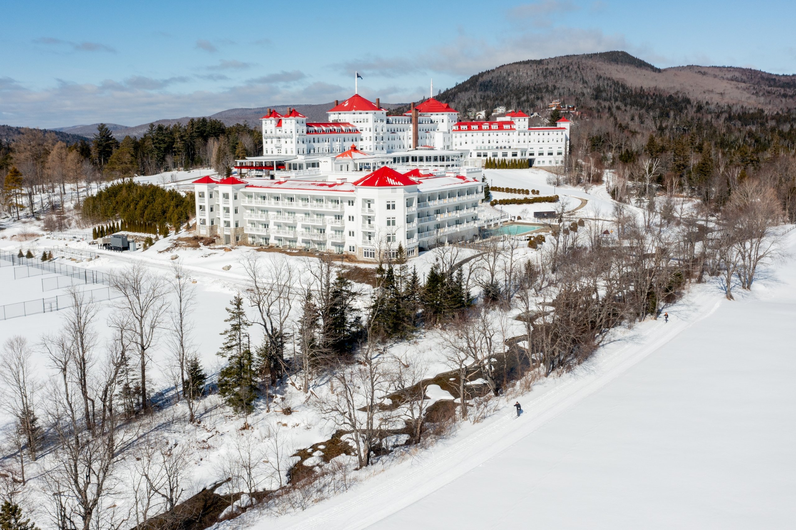 Mount Washington Resort and Spa sits at the base of a mountain surrounded by a snowy landscape.