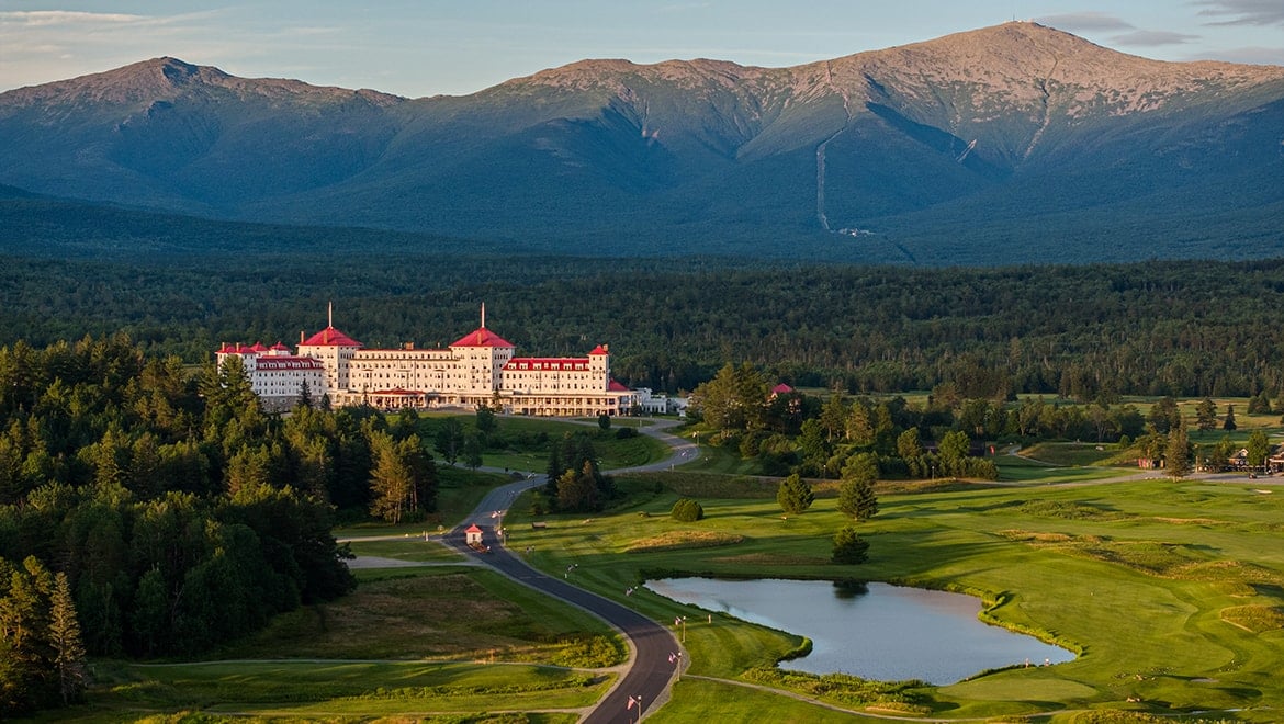A winding road leads to Mount Washington Resort and Spa sitting at the base of a mountain.