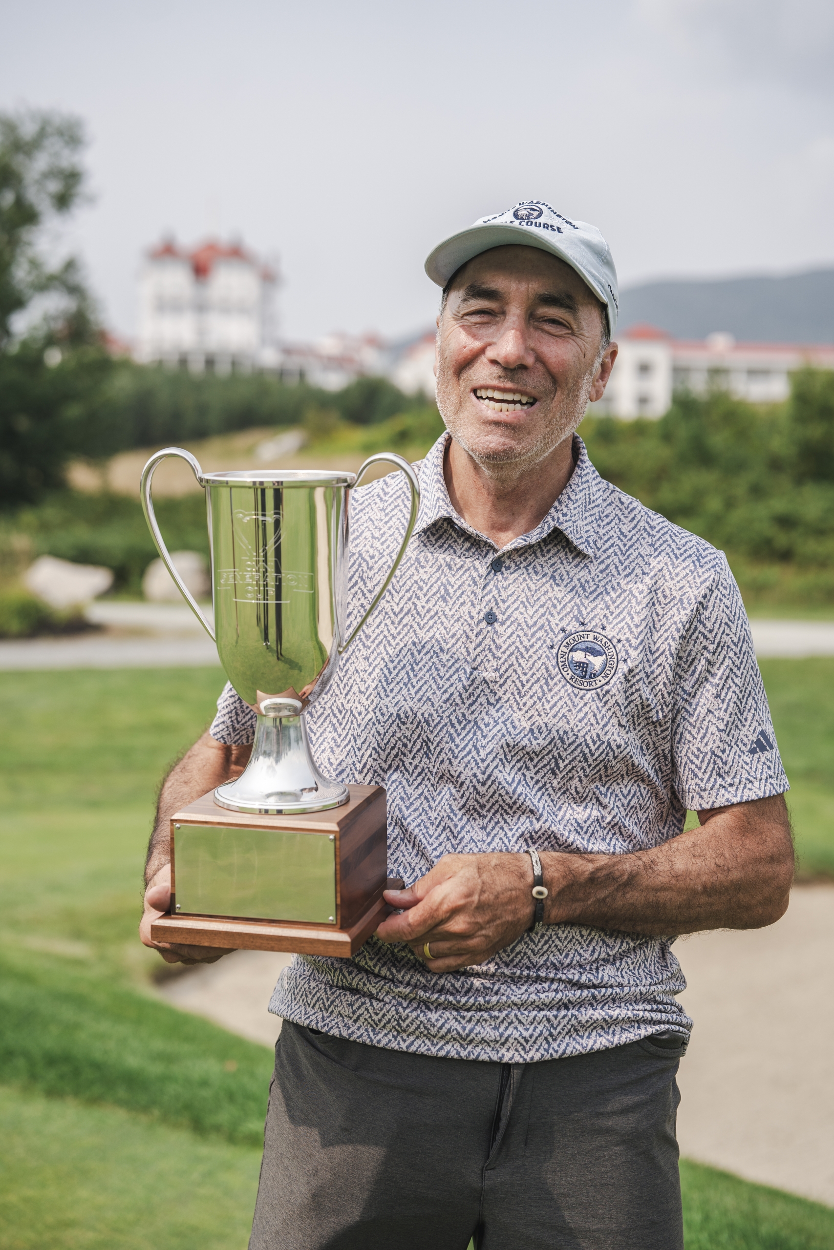 A man proudly holds a trophy at Mount Washington Resort and Spa.