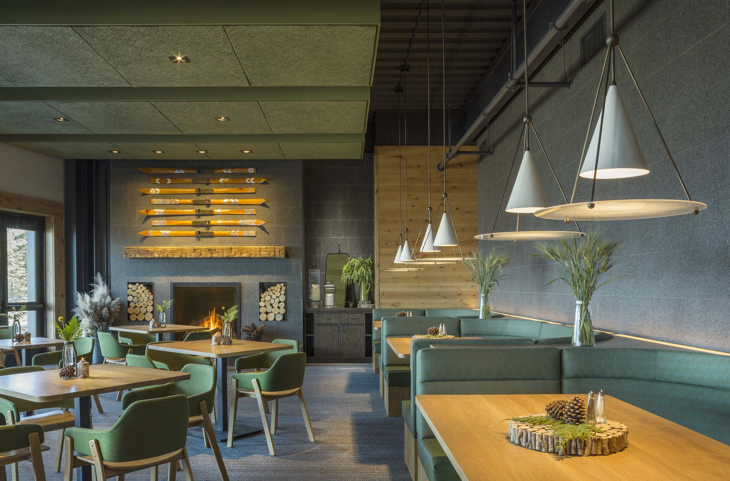The dining room with booths, tables and a fireplace at Switchback Grille.