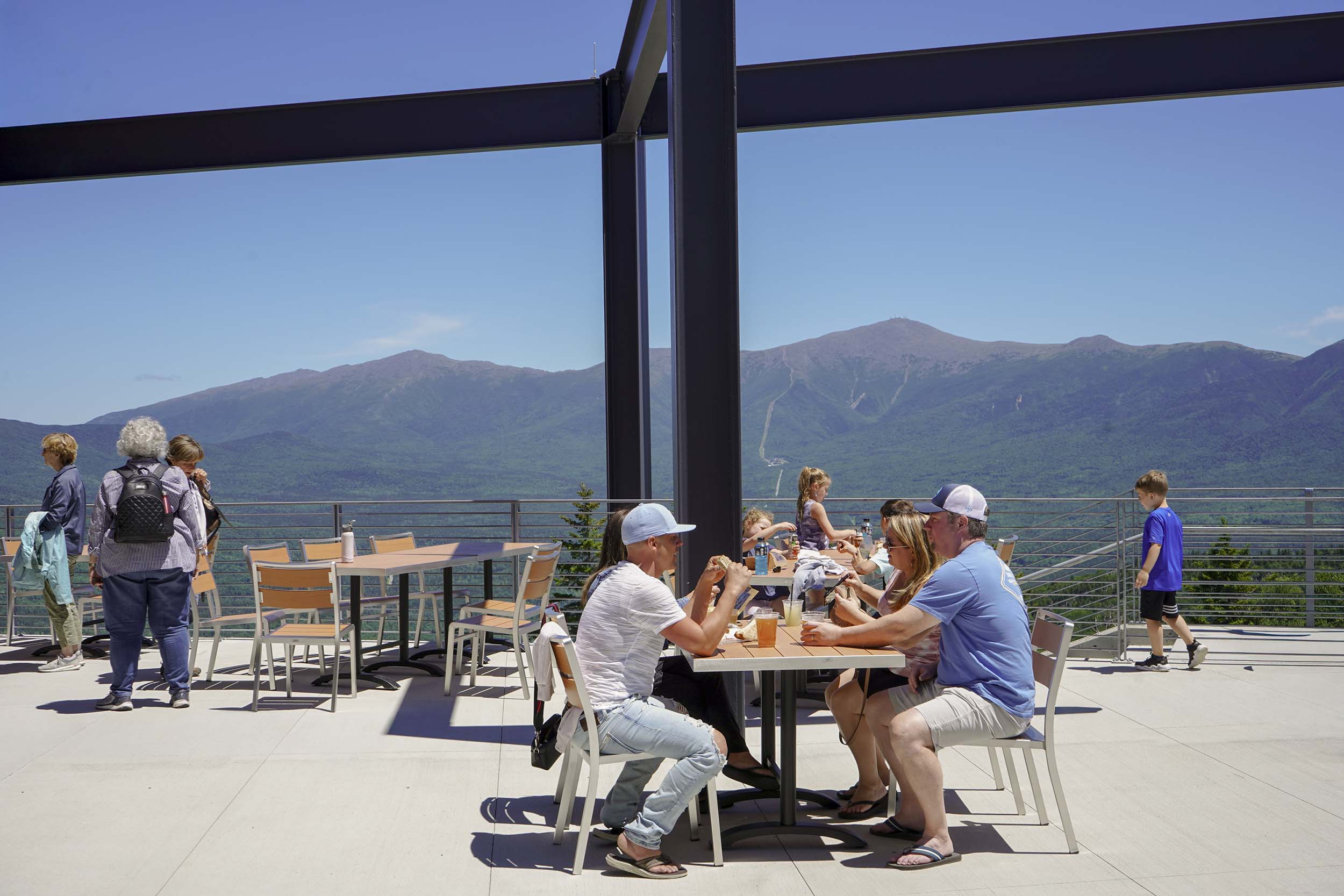 Diners sit on the outdoor patio outstide Rosebrook Lodge at Bretton Woods.