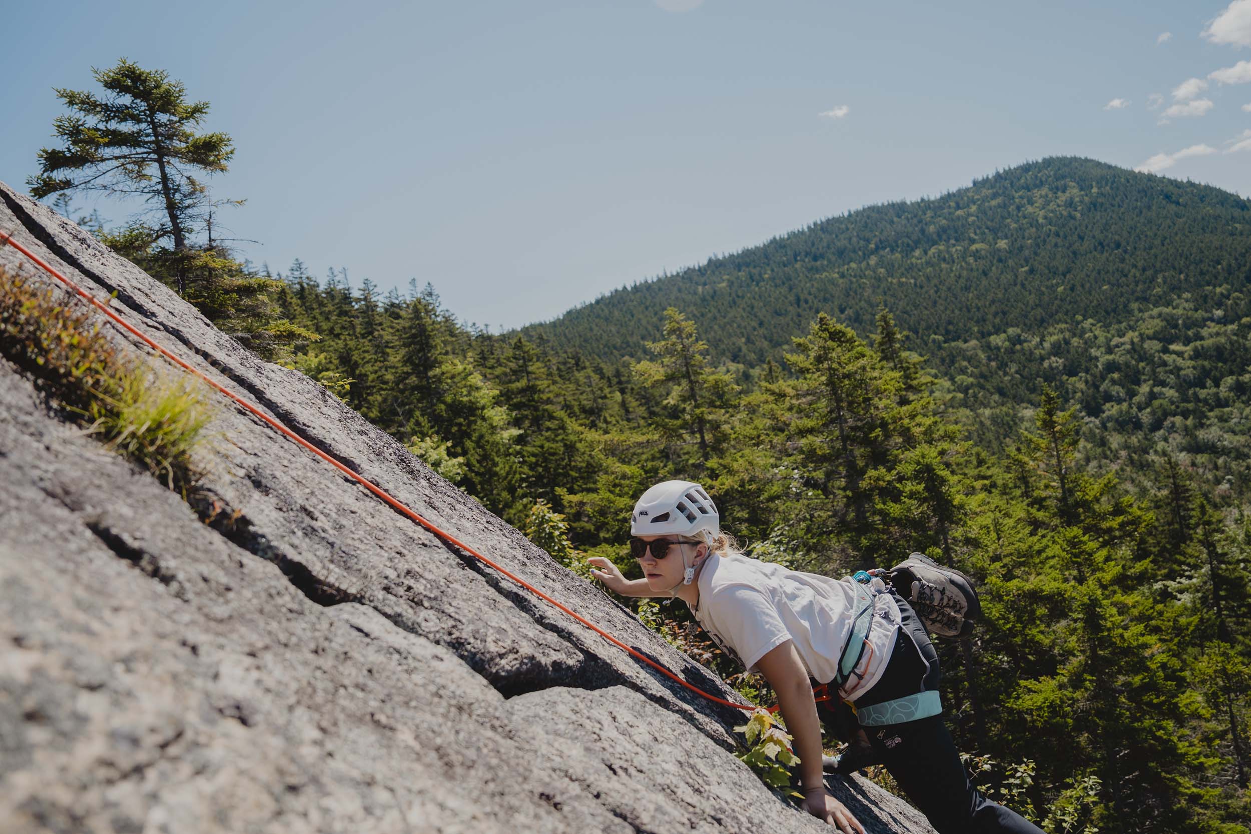 A rock climber maneuvers a handhold on the West Wall at Bretton Woods