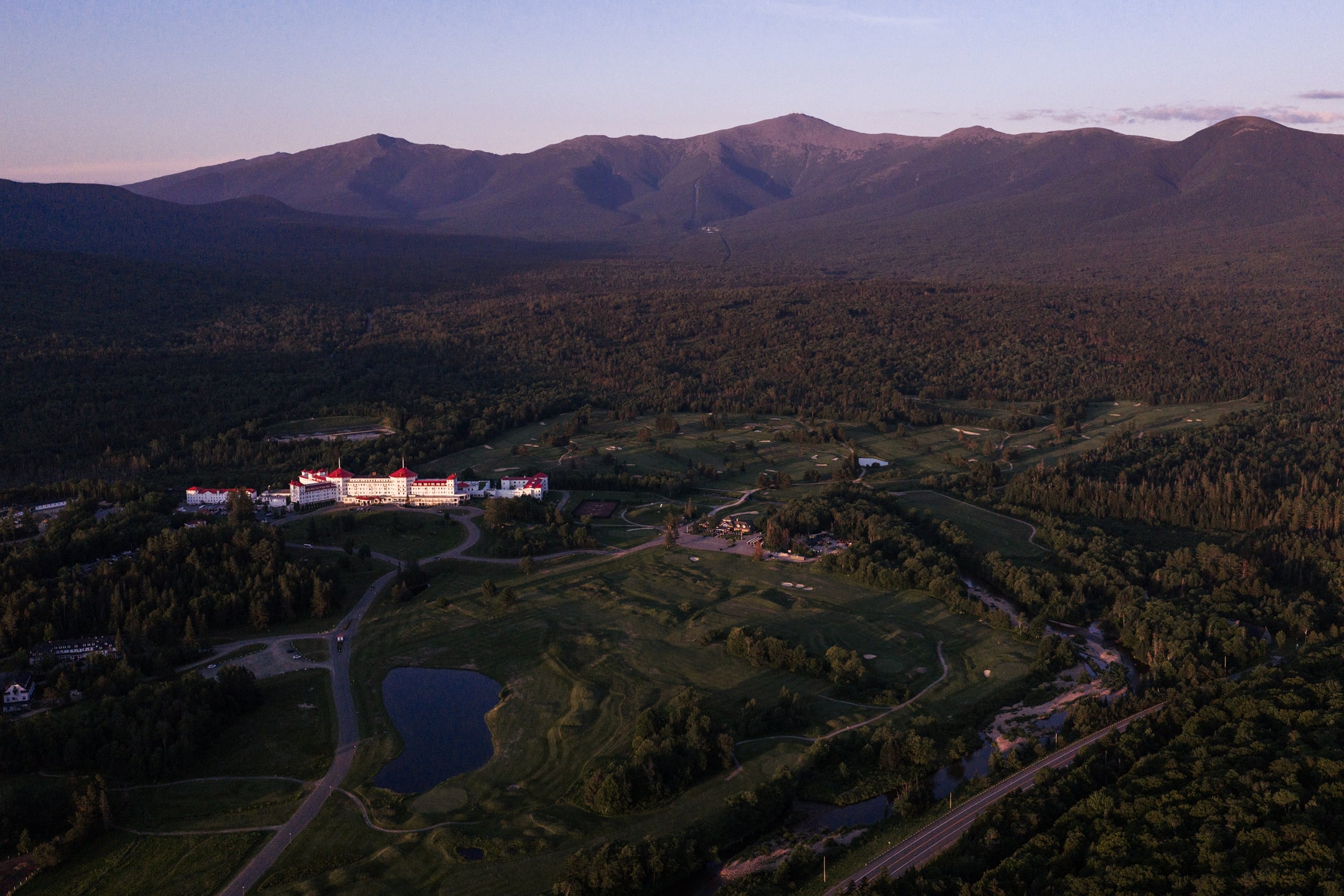 Drone shot of Omni Mount Washington Resort & Spa and Mount Washington at sunset