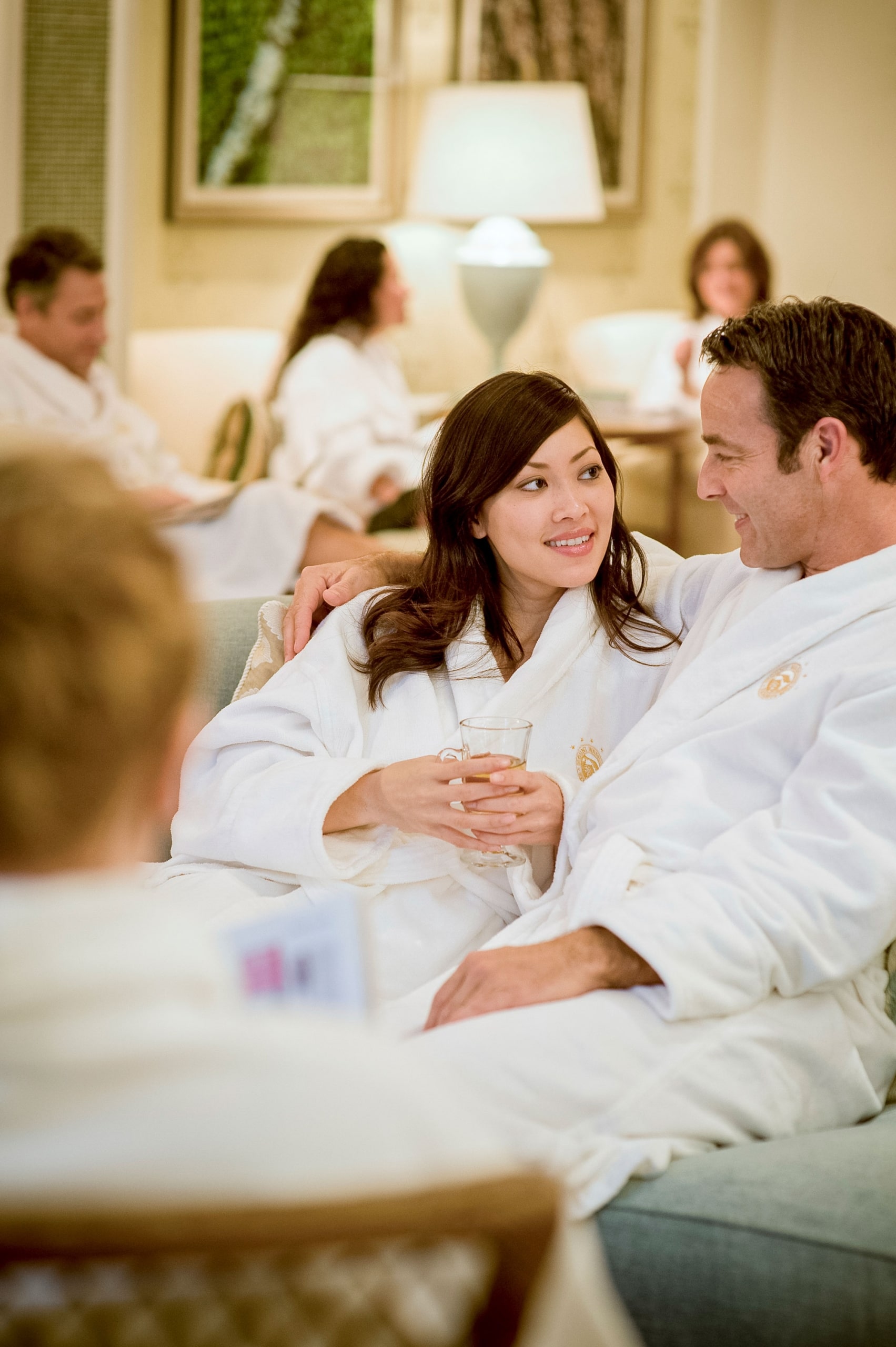 A man and woman relax in their bath robes at Mount Washington Resort and Spa.