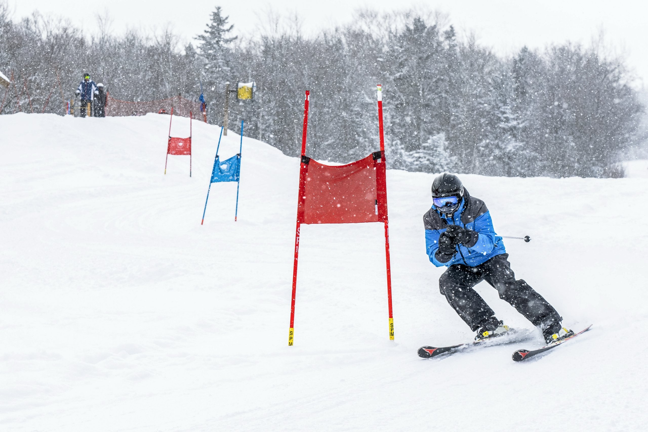 A ski racer passes a flag as they ski down the slope at Bretton Woods.