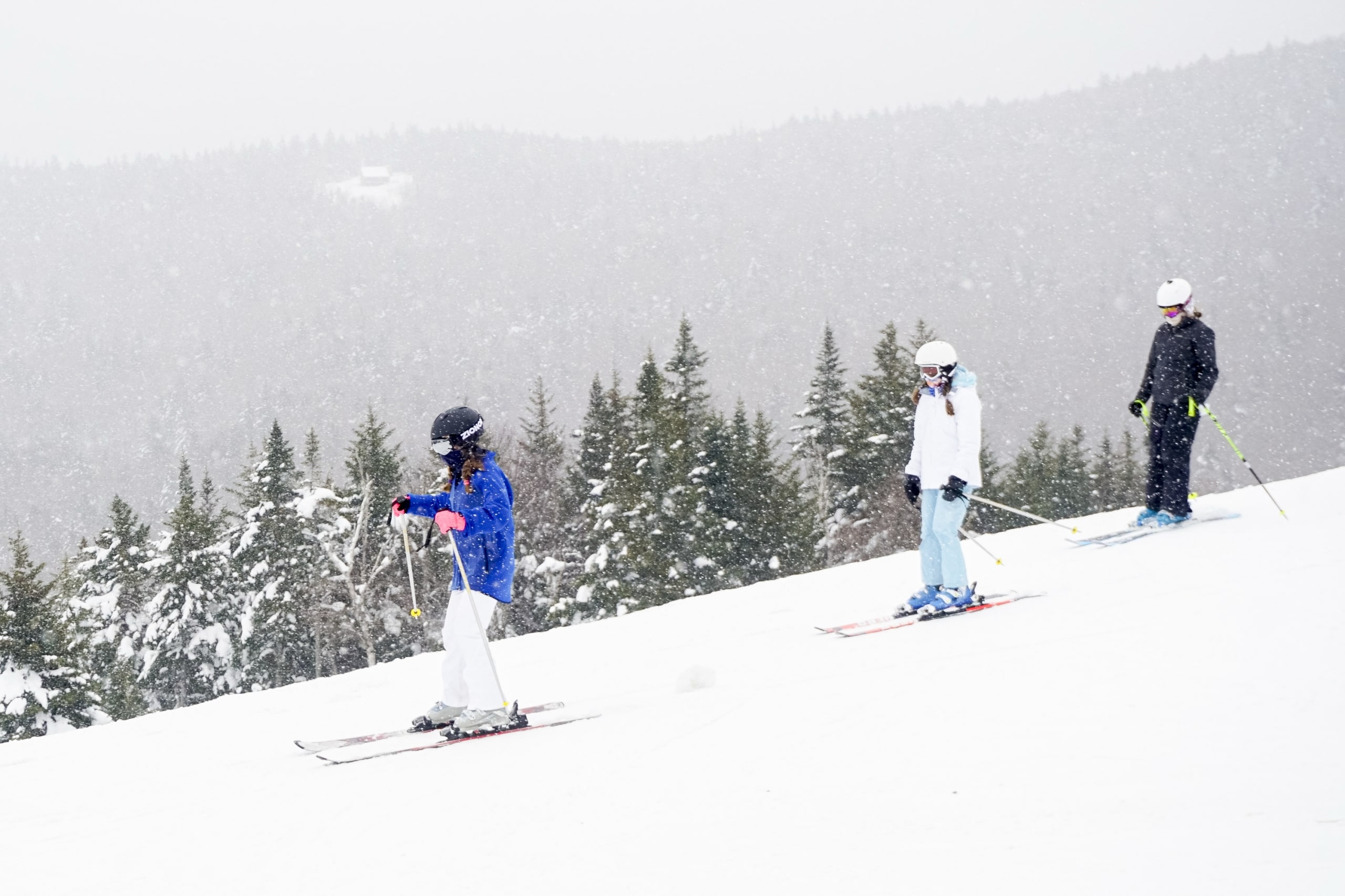 A group of skiers in a line descend the slope at Bretton Woods.
