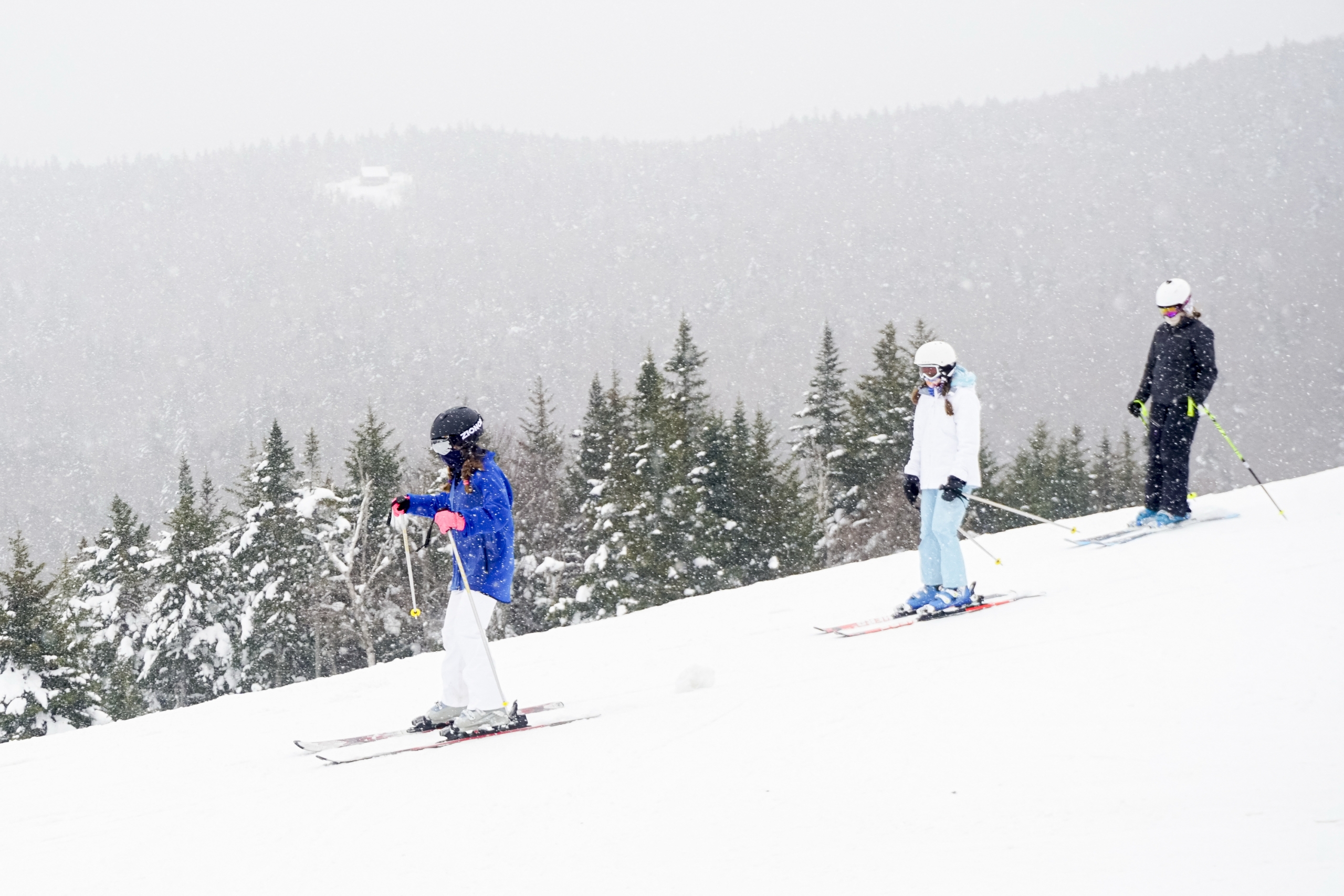 A group of skiers in a line descend the slope at Bretton Woods.