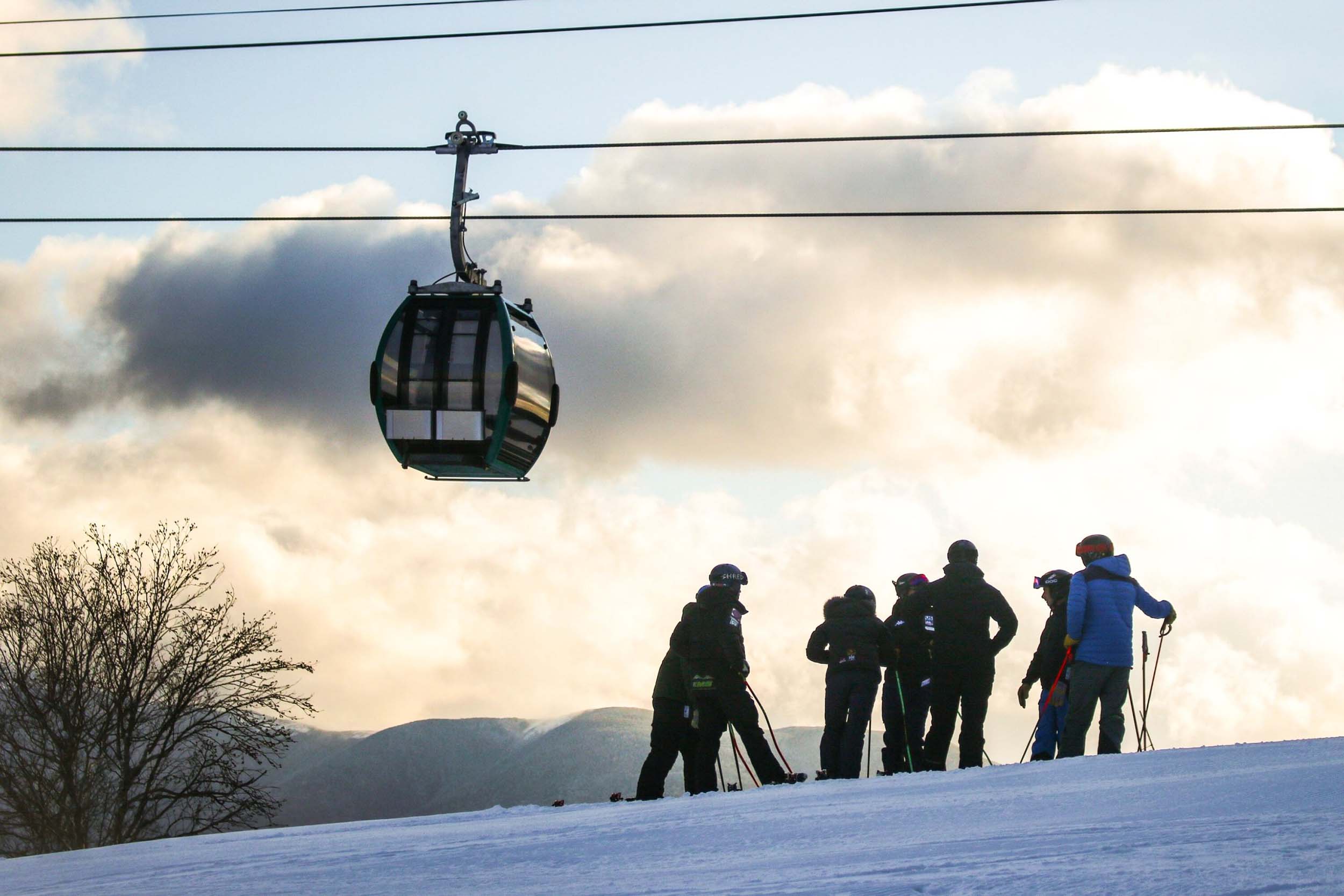 A group of skiers at the top of a snowy hill at Bretton Woods.