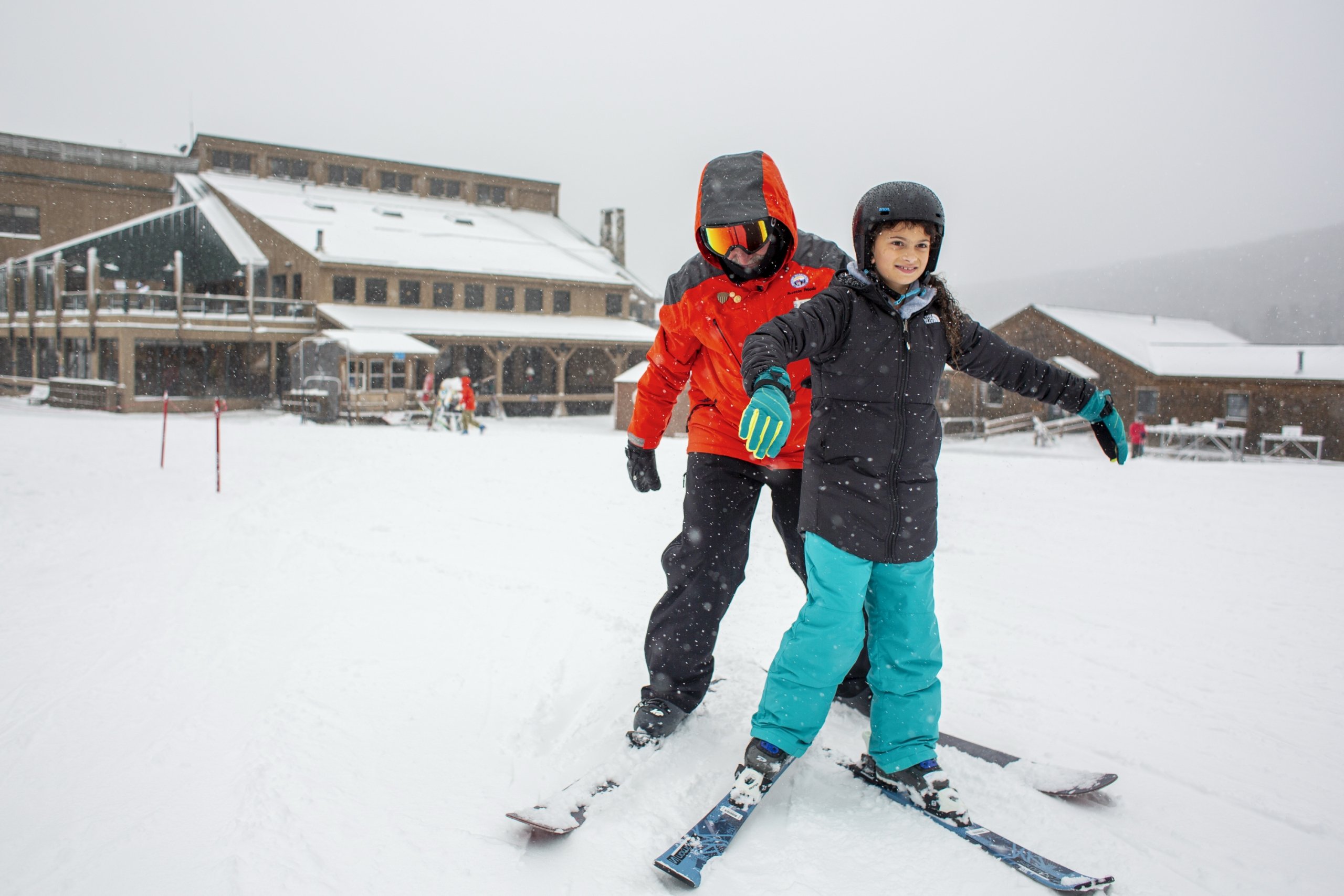 A ski instructor helps a young student balance on skis near the lodge at Bretton Woods.