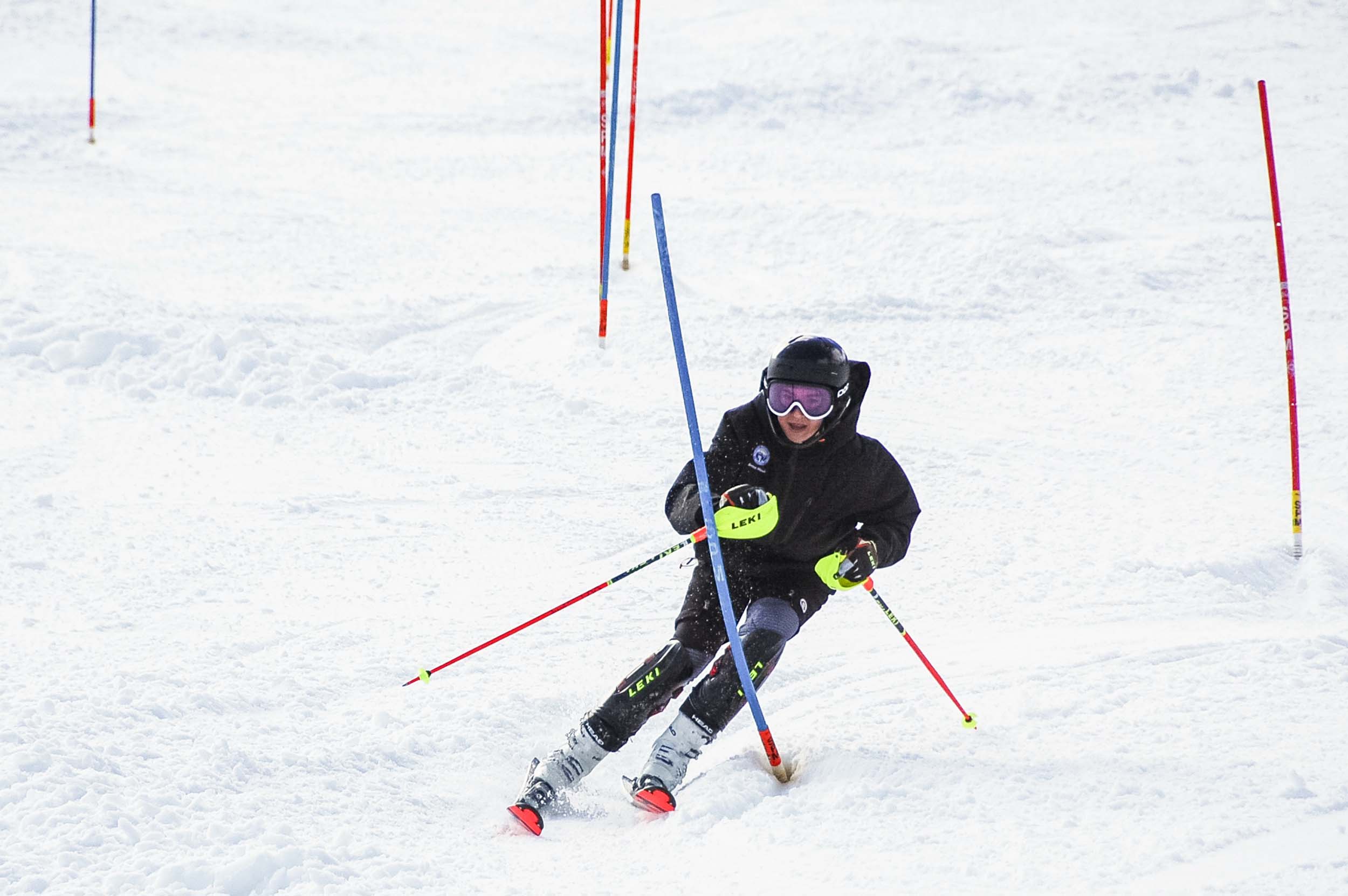 A youth skier weaves between poles down the slope at Bretton Woods.