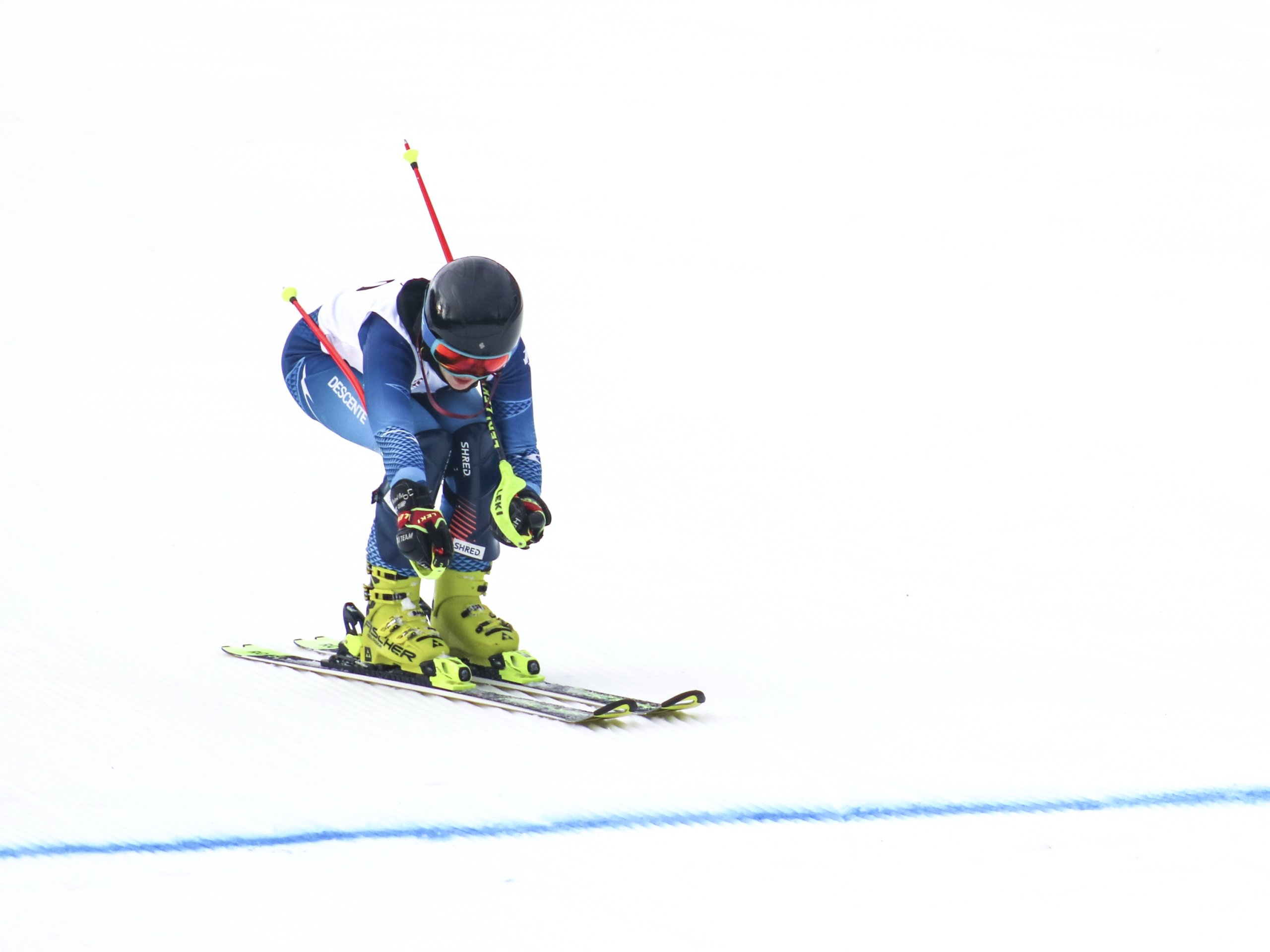 A ski racer crouched down as she speeds down the hill at Bretton Woods.