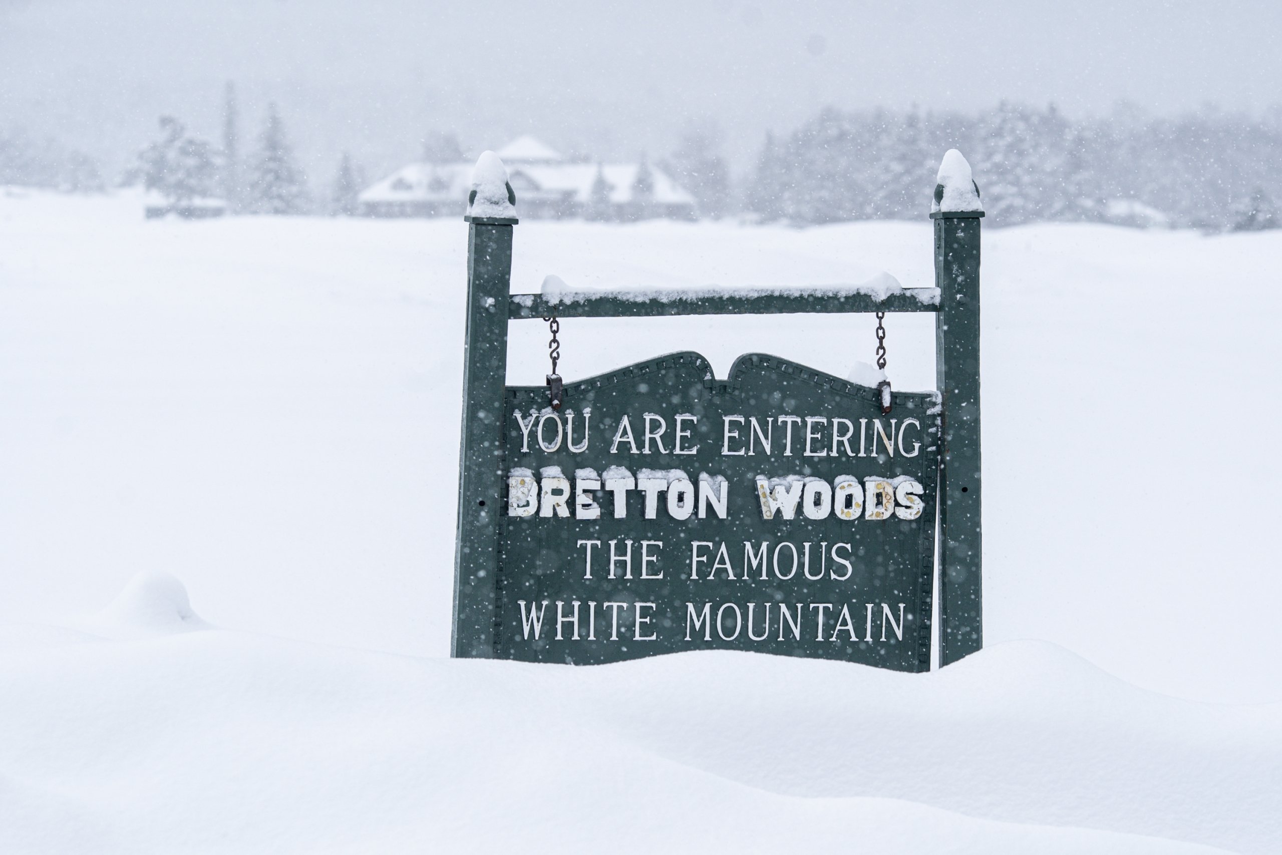 Entrance sign for Bretton Woods buried in fresh snow.