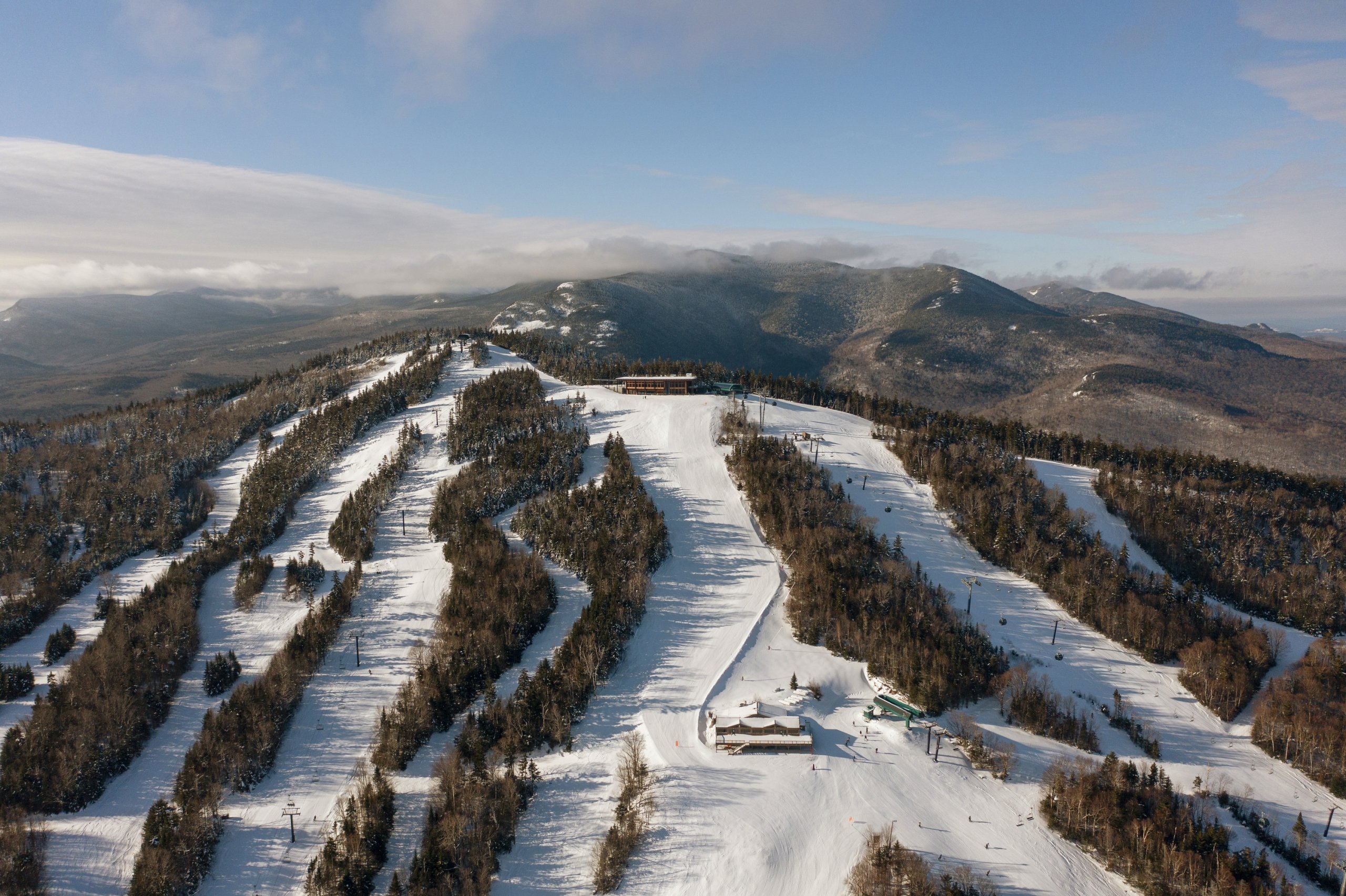 Aerial view of Bretton Woods Ski Area with multiple groomed trails winding down a forested mountain.