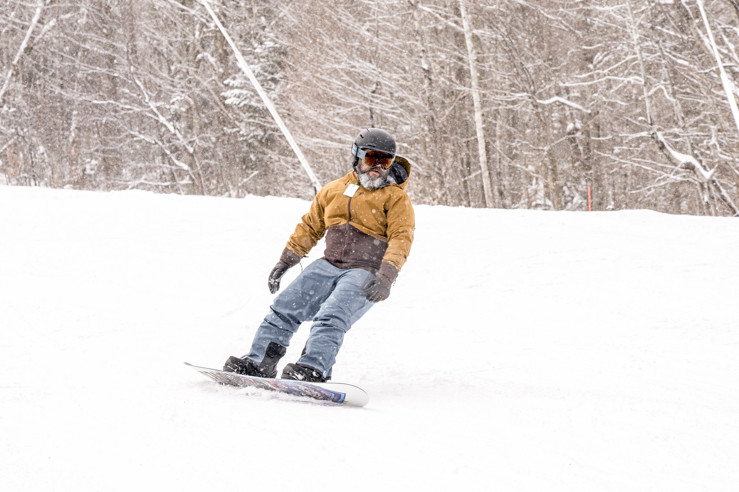A snowboarder carves through fresh snow on the mountain slope at Bretton Woods.