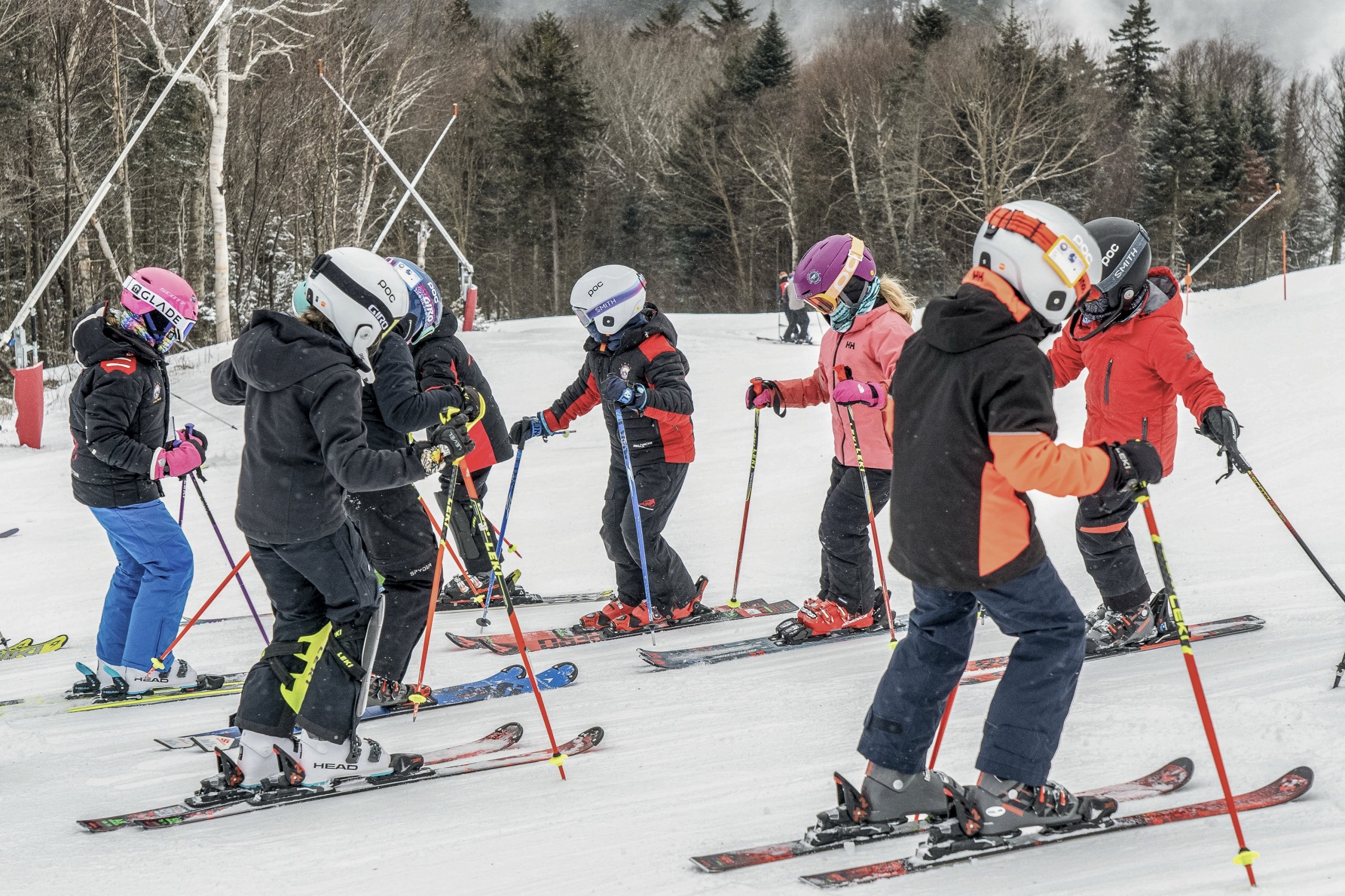 A group of skiers gathers on a snowy ski hill at Bretton Woods.