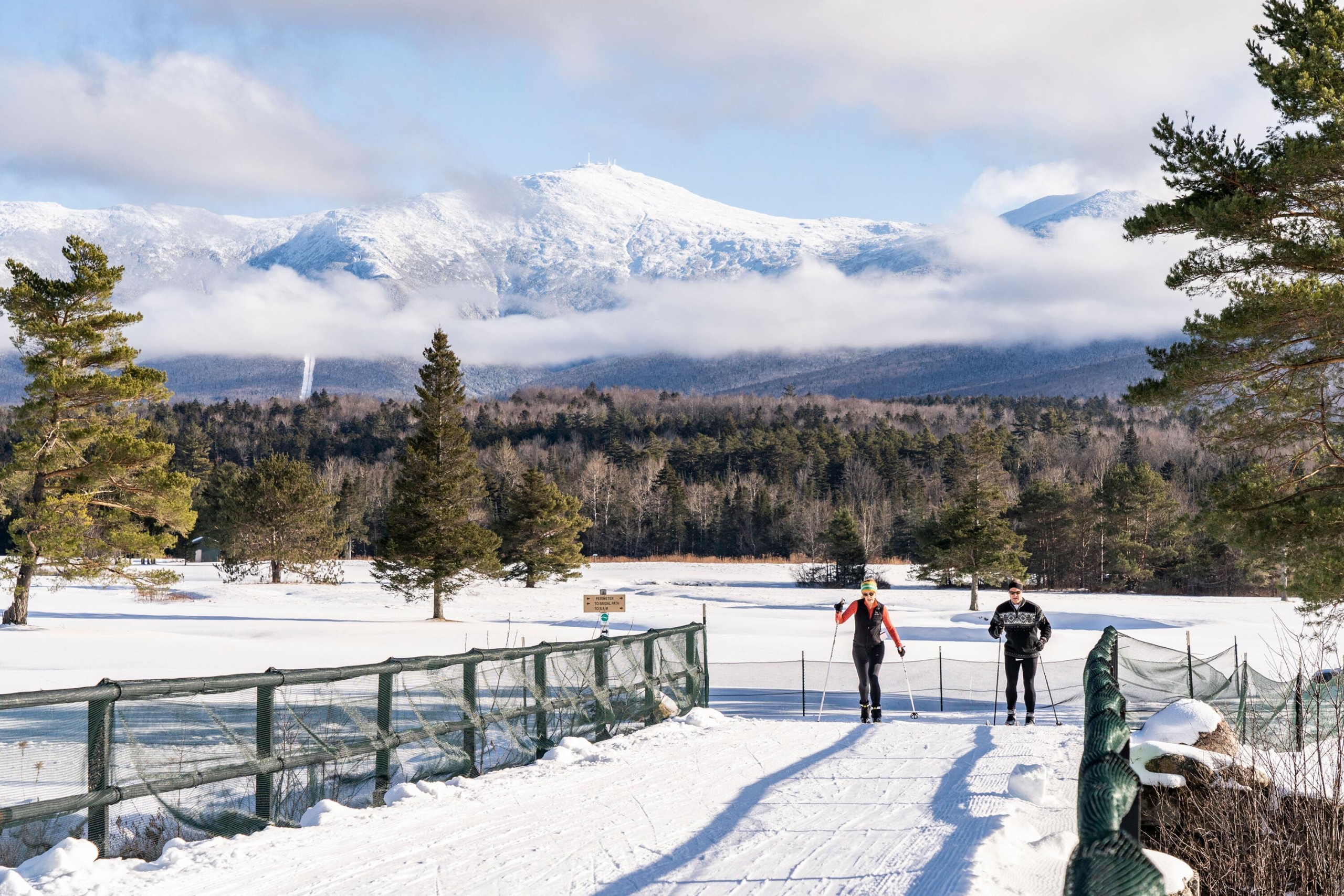 Nordic cross-country skiers cross a bridge at Bretton Woods.