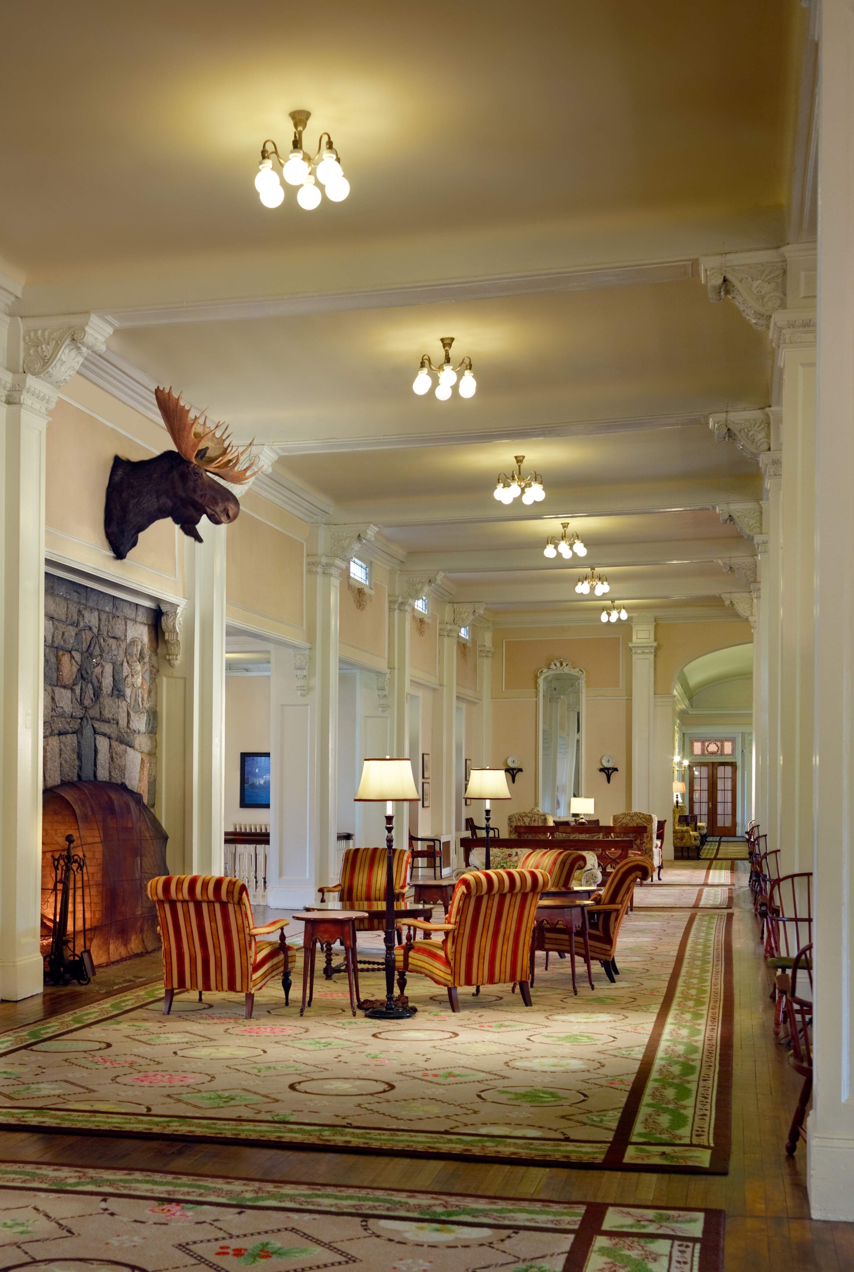 Lounge area with a comfortable chairs facing a fireplace at Mount Washington Resort and Spa.