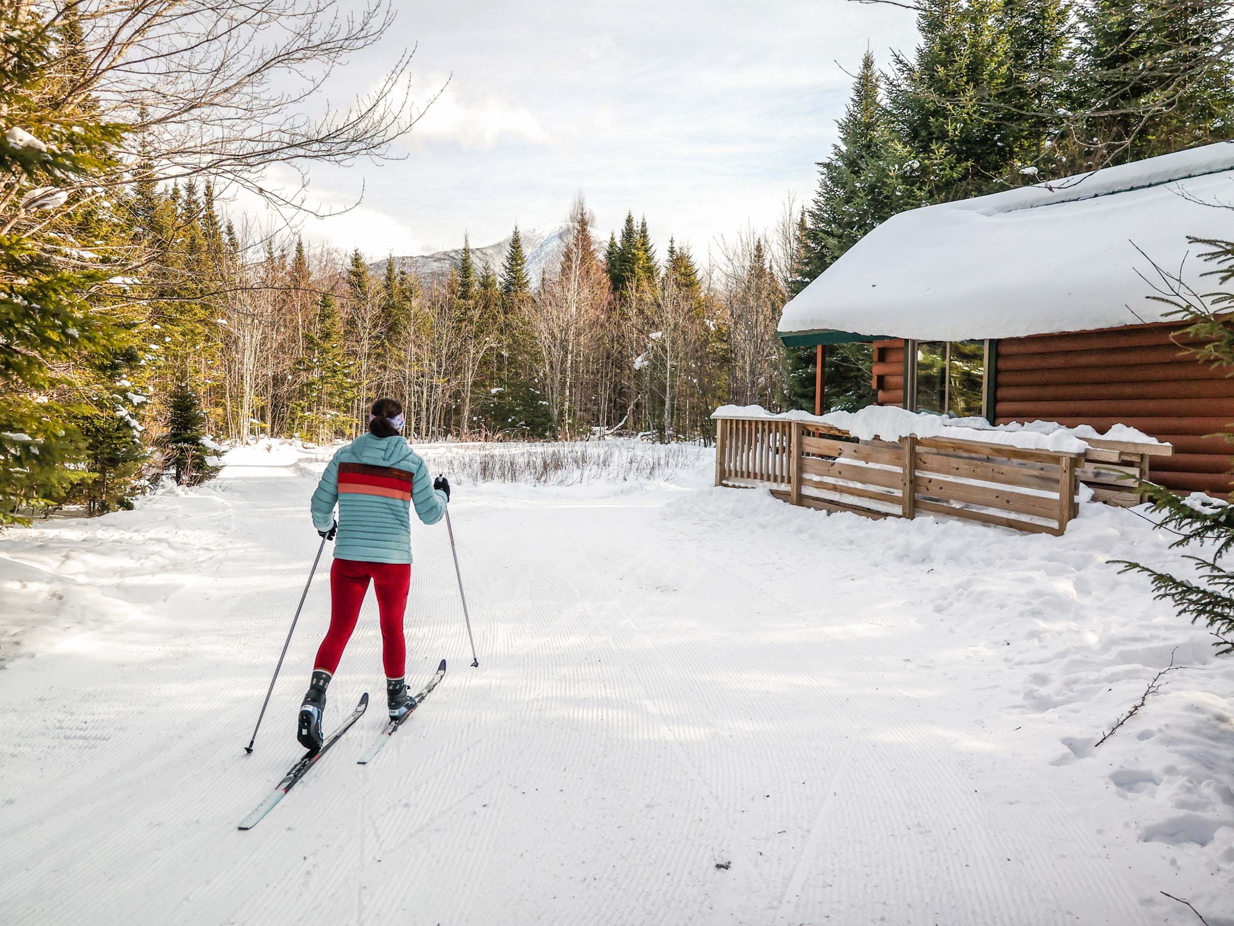 A cross-country skier glides through the snowy trails in the forest at Mount Washington Resort and Spa.