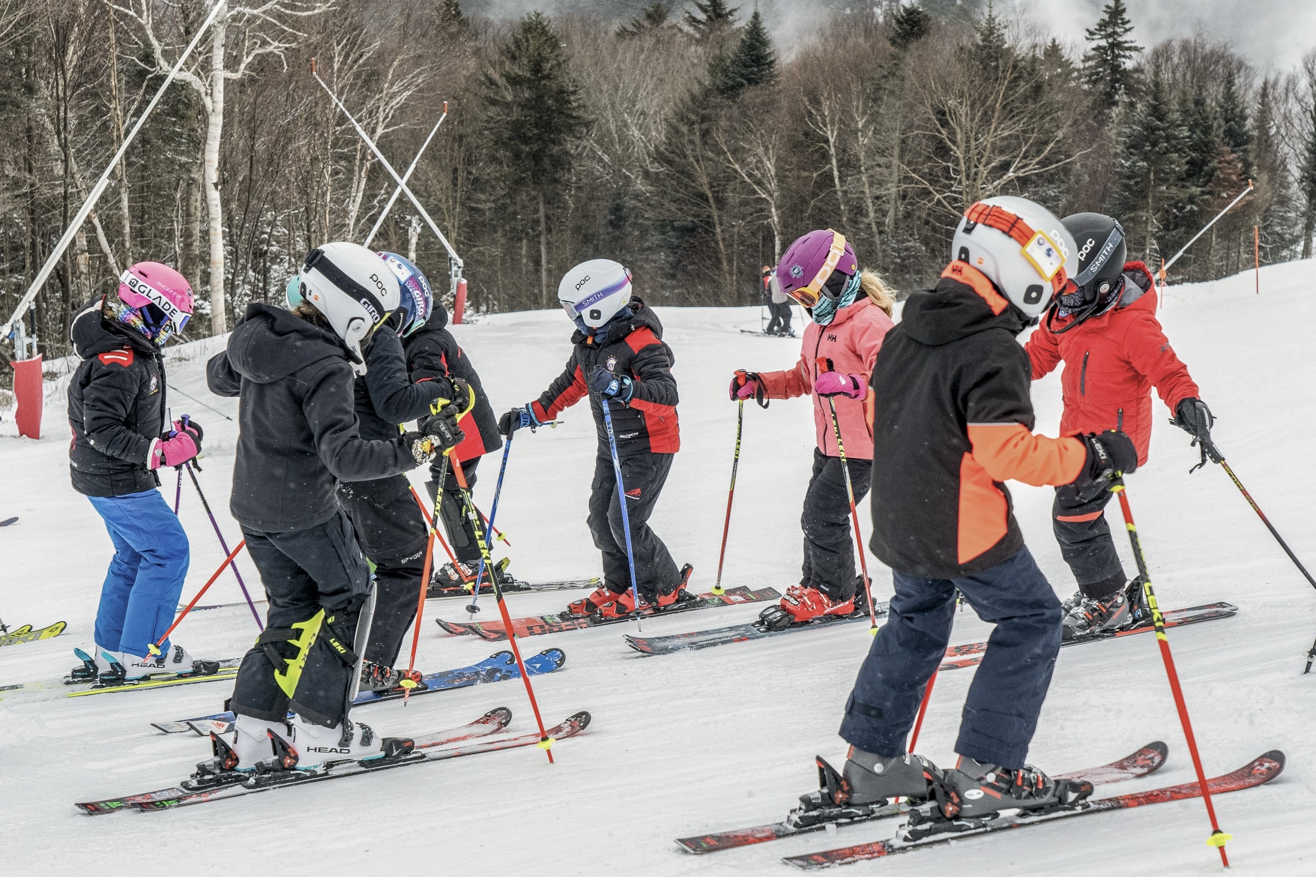 A group of skiers gathers on a snowy ski hill at Bretton Woods.