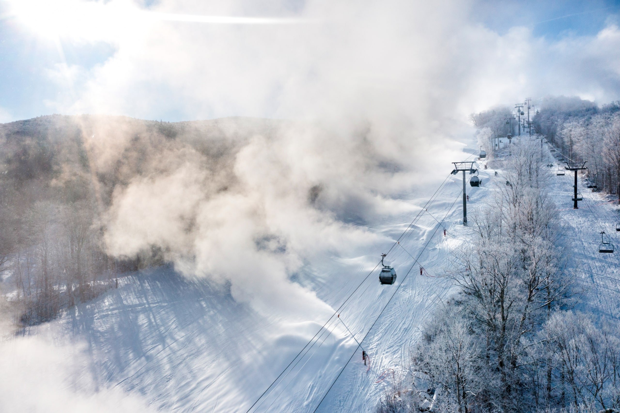 Aerial view of the gondolas going up the mountain on a snowy day